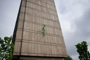 Three green bikes emerge from the wall of Roehampton Library
